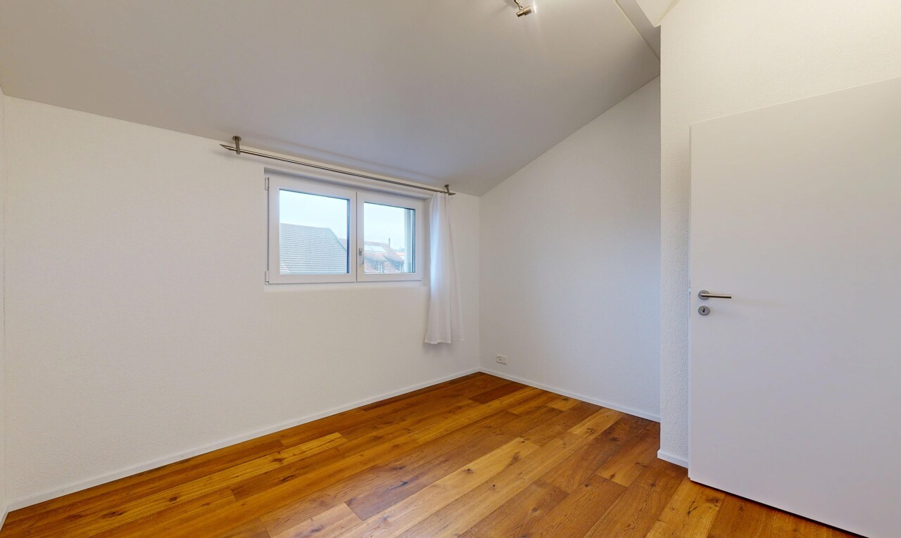 pièce vide avec vaulted ceiling, plafond voûté, wood finish floor, sol en finition bois, et inside property