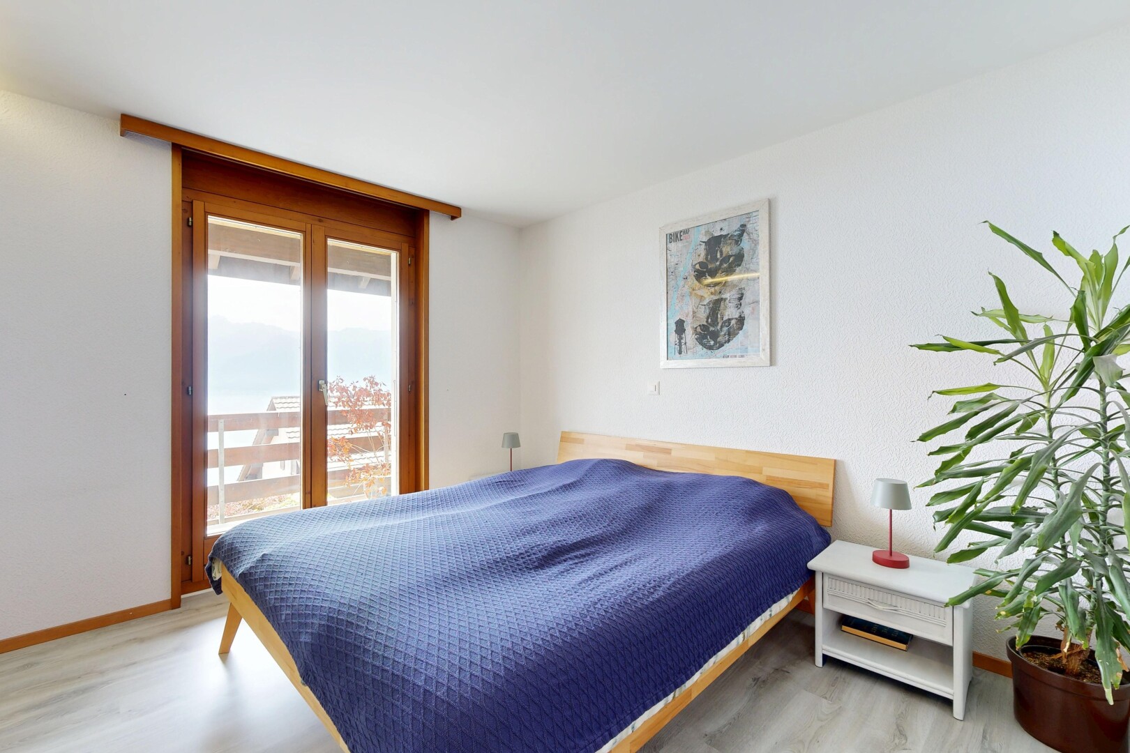 room / bedroom with light wood-type flooring and access to exterior