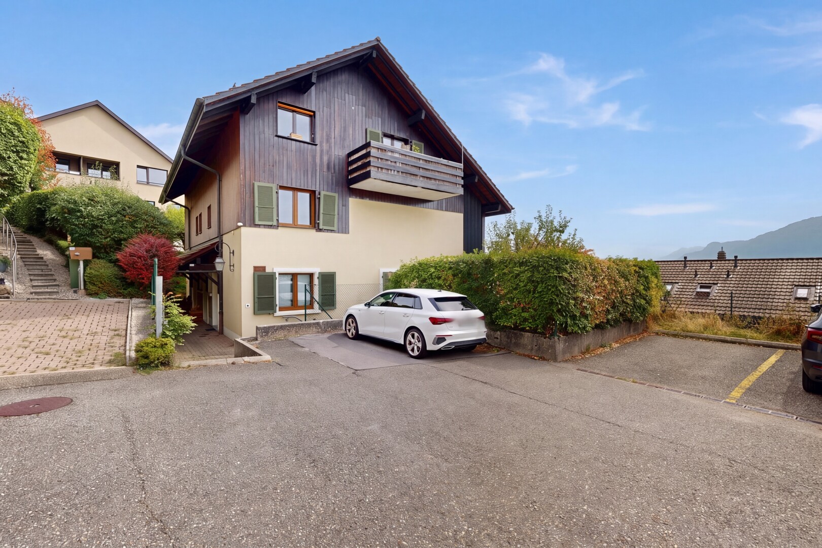 view of home featuring uncovered parking
