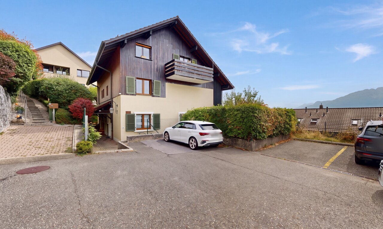 view of home featuring uncovered parking