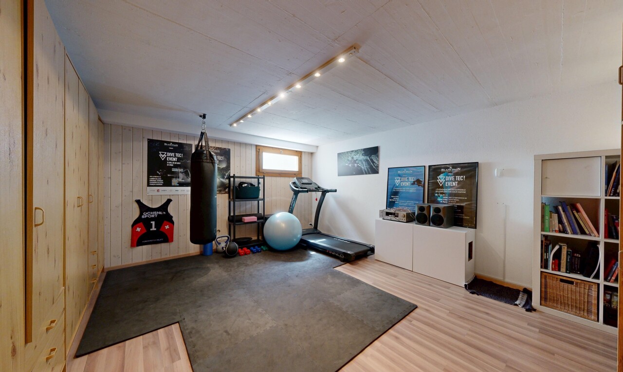 workout area featuring wooden walls and wood finished floors