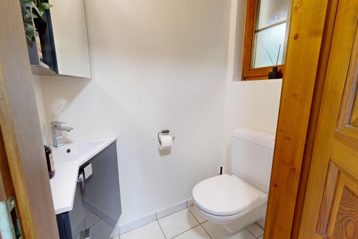 half bath with light tile patterned flooring and vanity