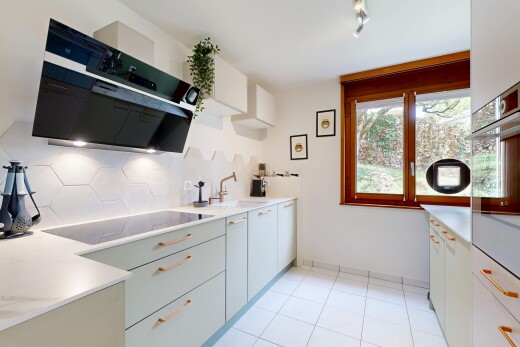 kitchen featuring track lighting, range hood, black electric stovetop, oven, and light tile patterned flooring