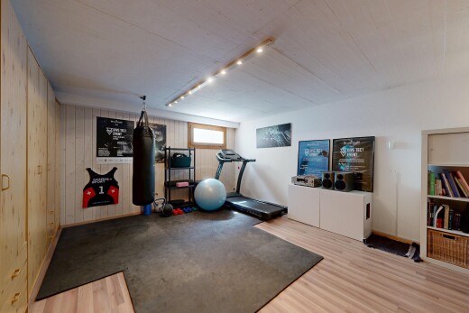 workout area featuring wooden walls and wood finished floors