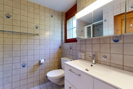 bathroom with a shower stall, tile walls, vanity, and light tile patterned floors