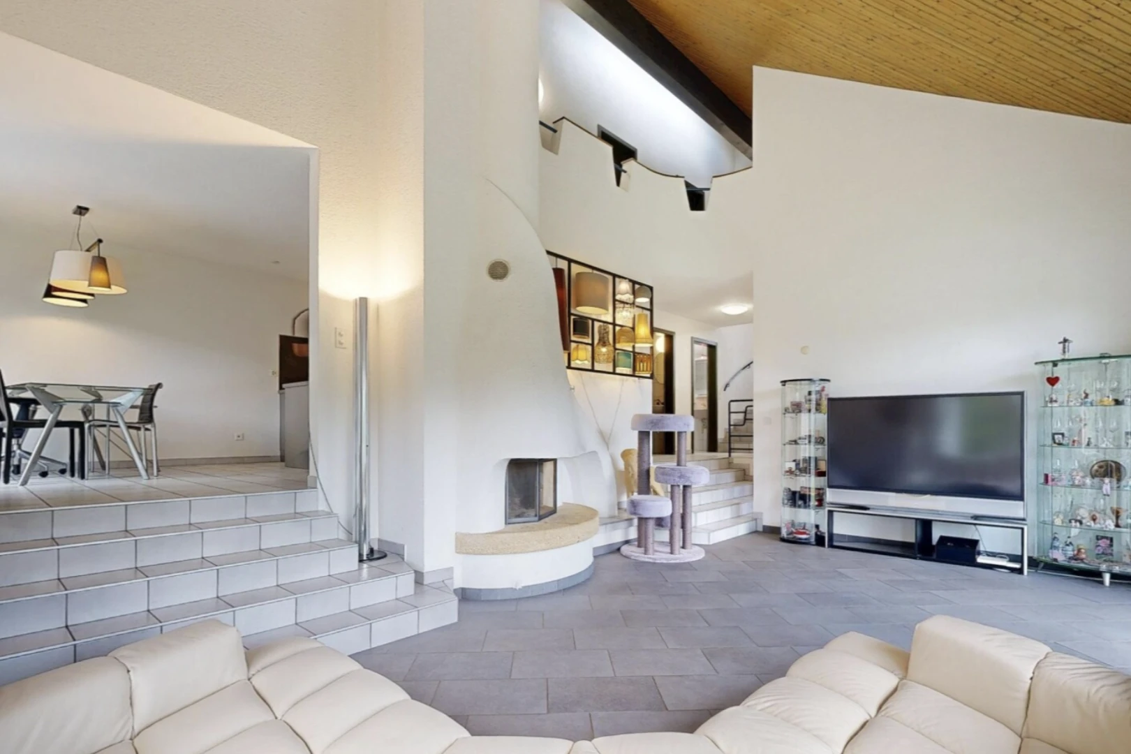 sunken living room with a vaulted wood ceiling and a large fireplace
