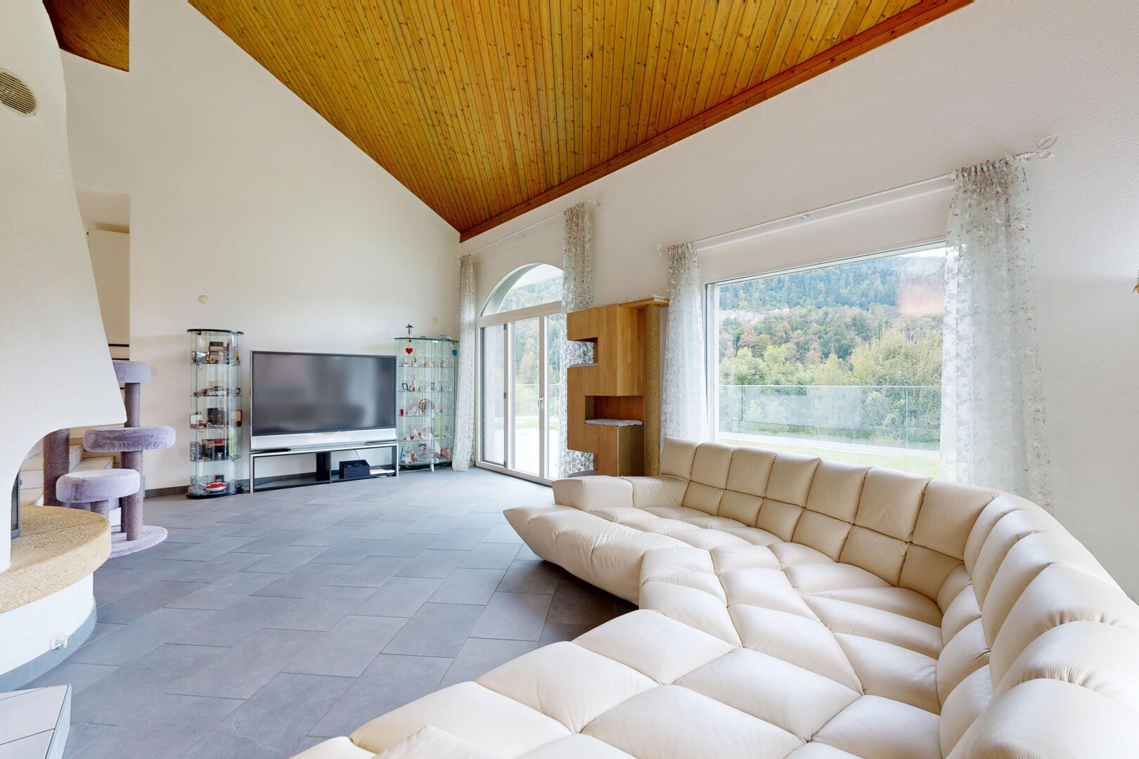 salon avec plafond haut, high ceiling, plafond voûté, vaulted ceiling, et télévision