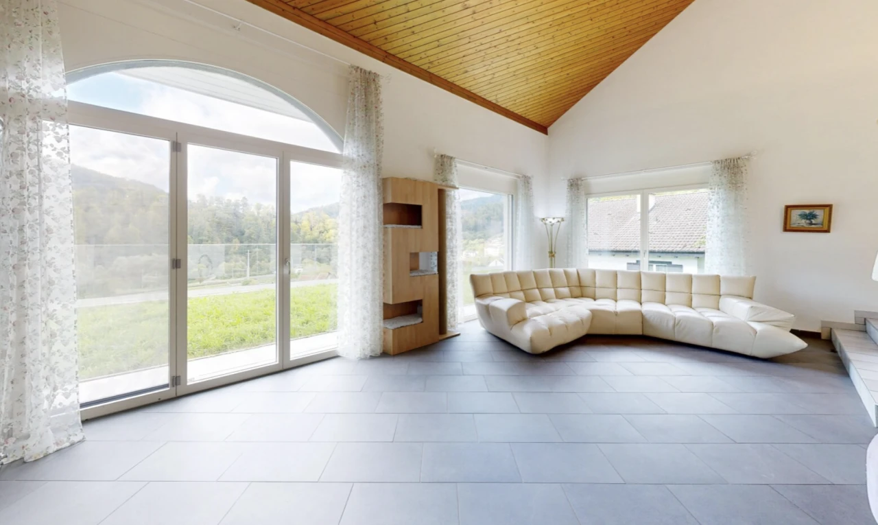 living room featuring a vaulted wood ceiling and access to outside