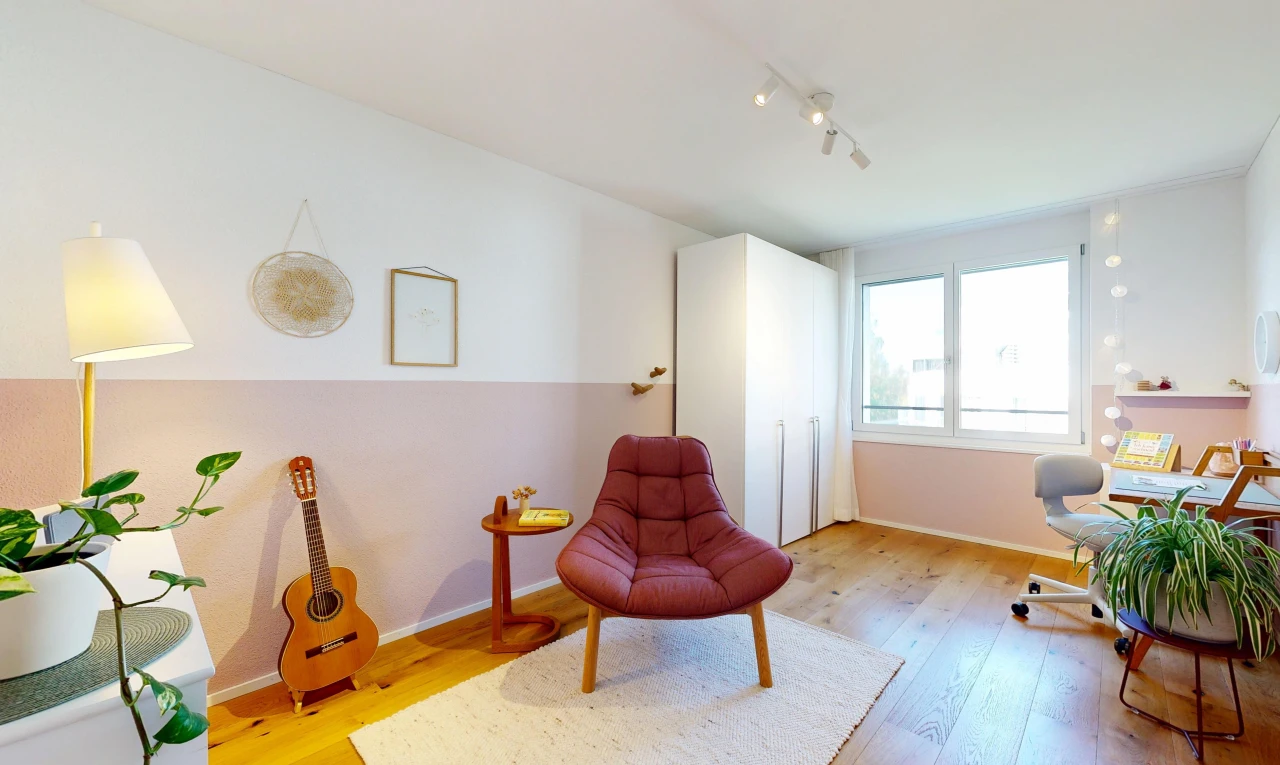 living area with light wood-style flooring and track lighting