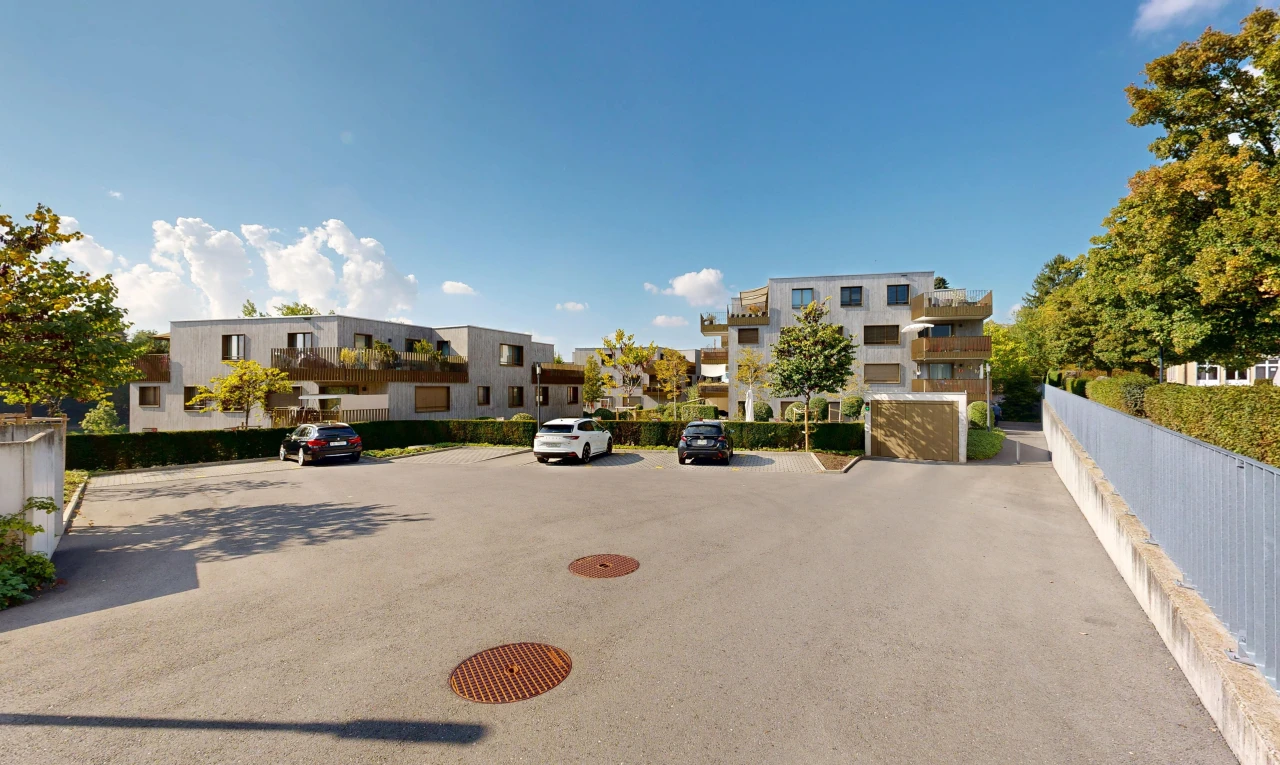 view of apartment building / complex featuring uncovered parking