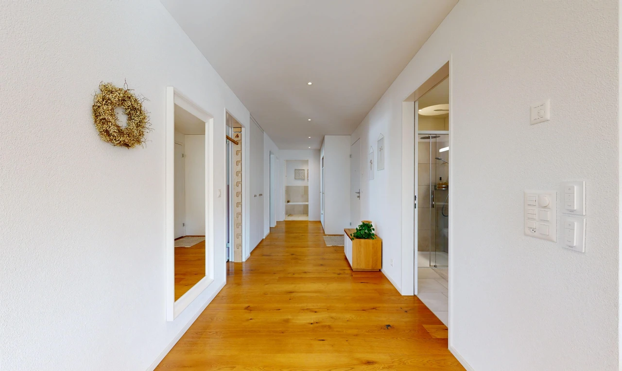 corridor with light wood-style floors and recessed lighting