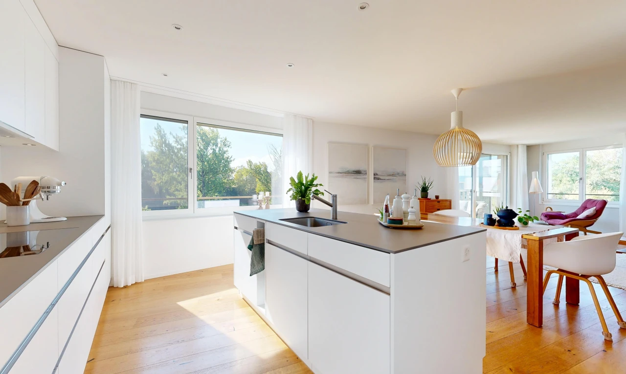 kitchen featuring white cabinets, an island with sink, dark countertops, and light wood-style floors