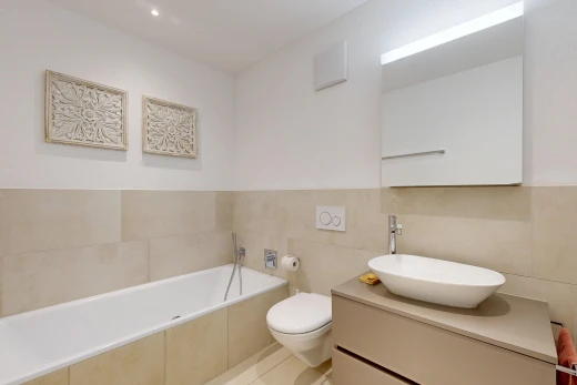 bathroom with a bath, recessed lighting, vanity, tile walls, and light tile patterned floors