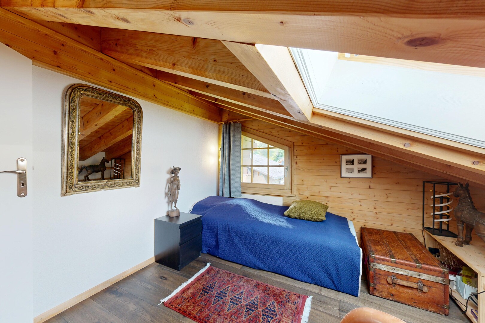 chambre avec sol en finition bois, wood finish floor, plafond voûté, vaulted ceiling, et lumière naturelle