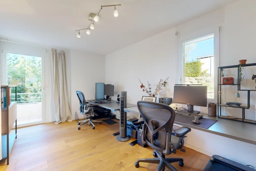 bureau avec éclairage sur rail, drywall, cloison sèche, wood finish floor, et sol en finition bois