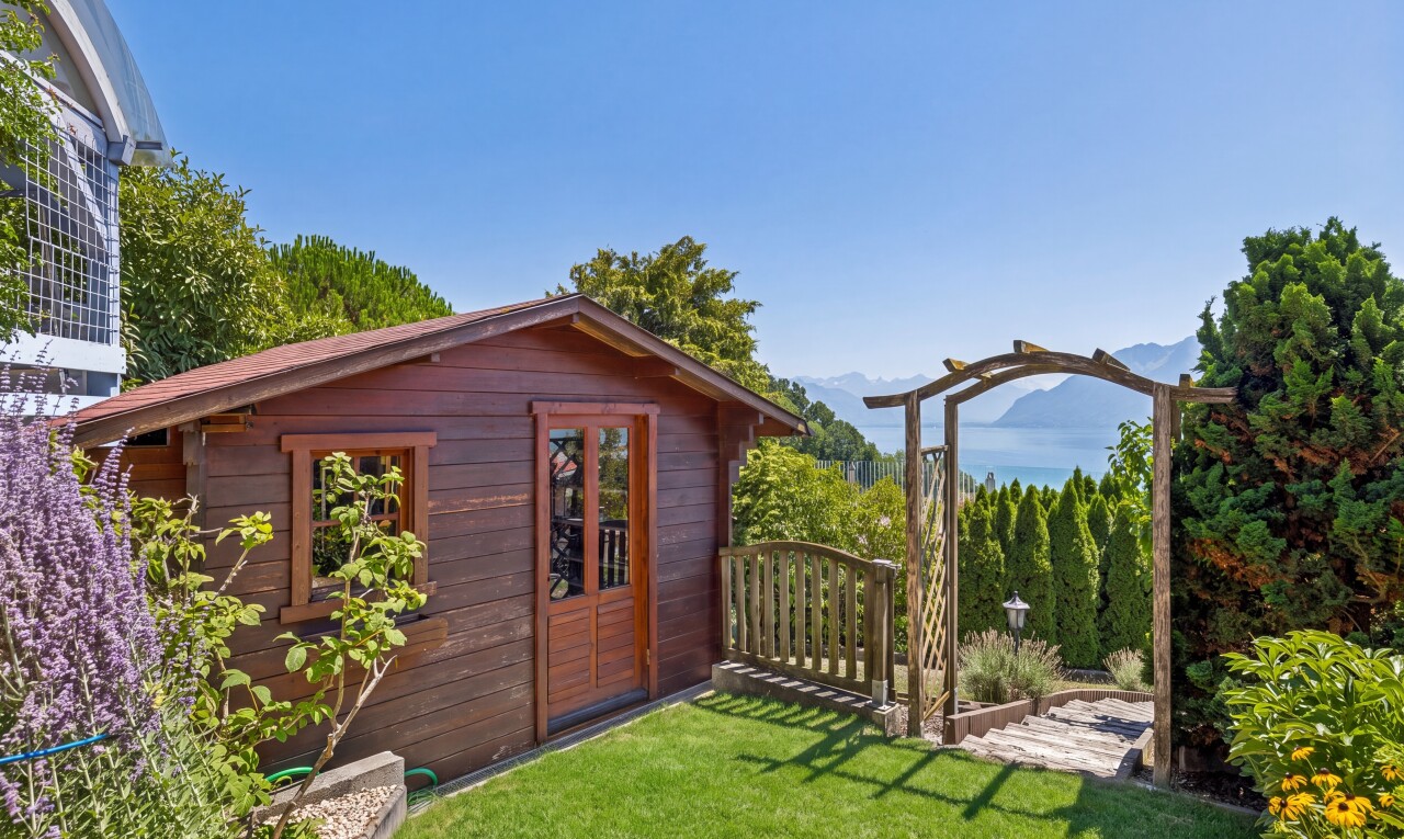 outdoor house with an outdoor structure and a lawn