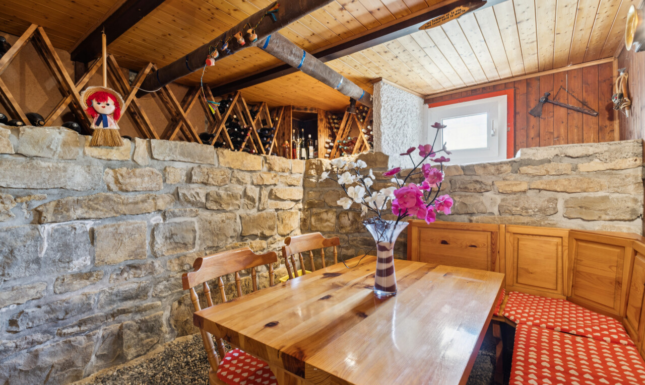 salle à manger avec plafond en bois, wood ceiling, mur en pierre, stone wall, et high end ceiling