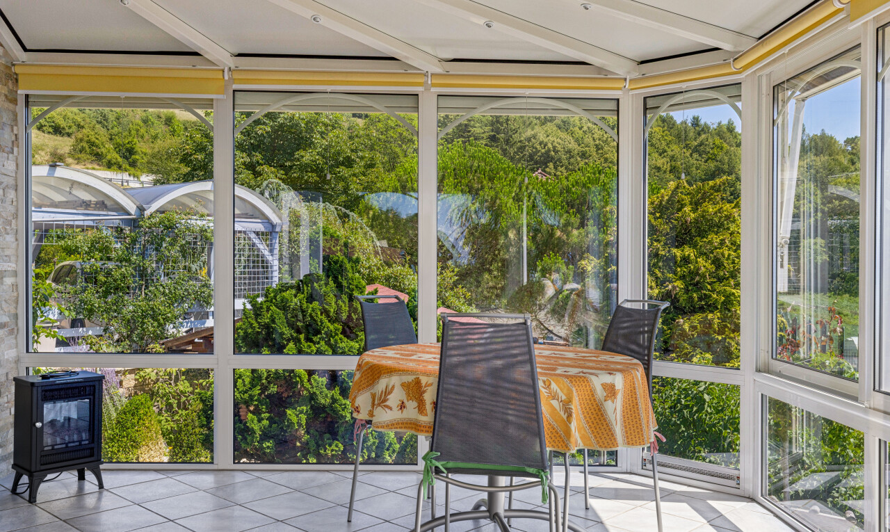 patio / terrace featuring a sunroom
