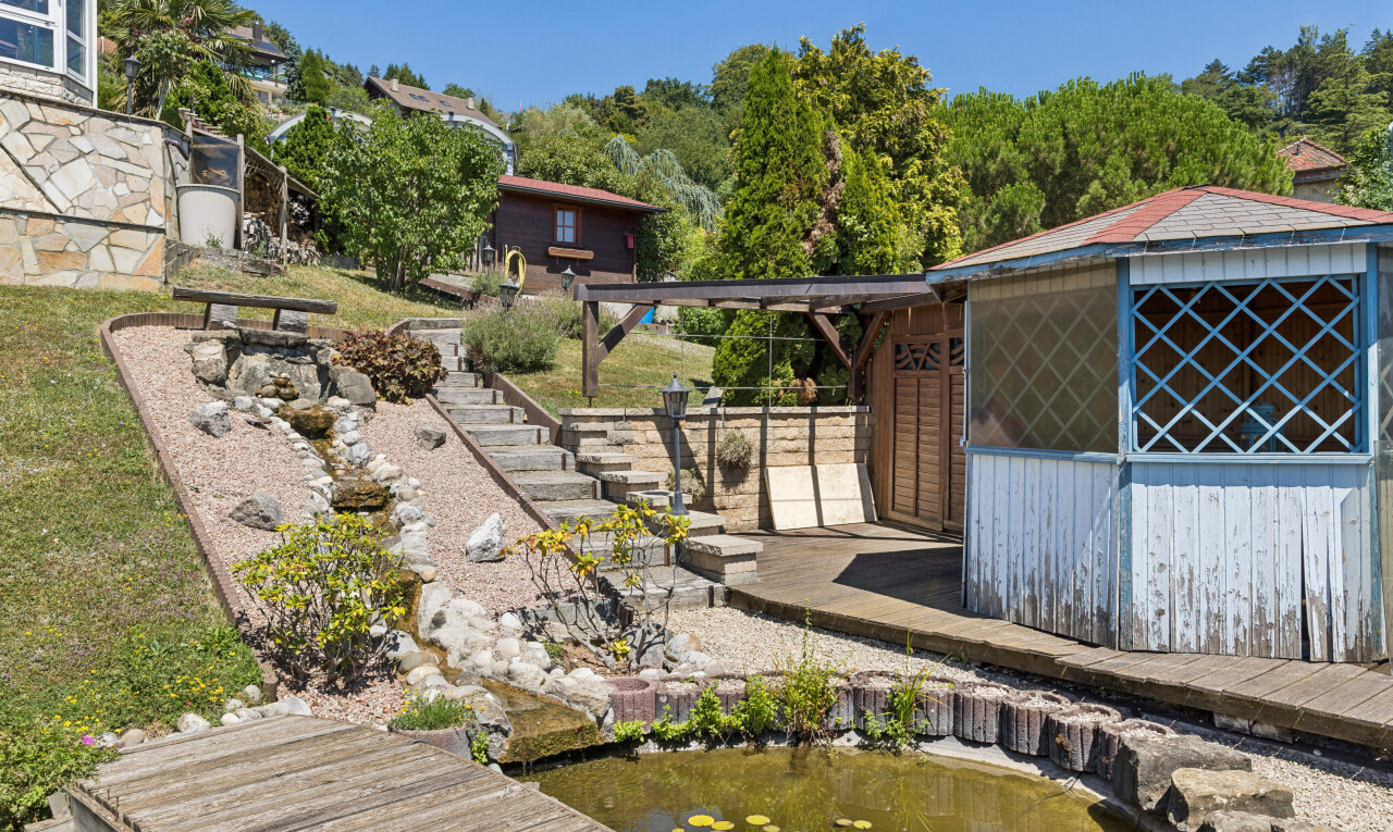 view of property with a small pond and a boat dock