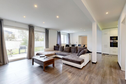 living area with dark wood-type flooring and recessed lighting
