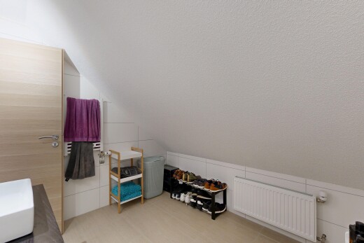 room / bedroom featuring radiator heating unit and vaulted ceiling