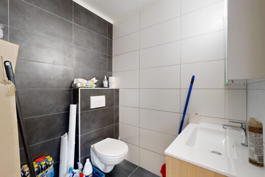 bathroom featuring tile walls, vanity, a textured ceiling, and tile patterned flooring