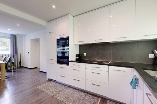 kitchen featuring oven, white cabinets, modern cabinets, dark wood-style flooring, and tasteful backsplash