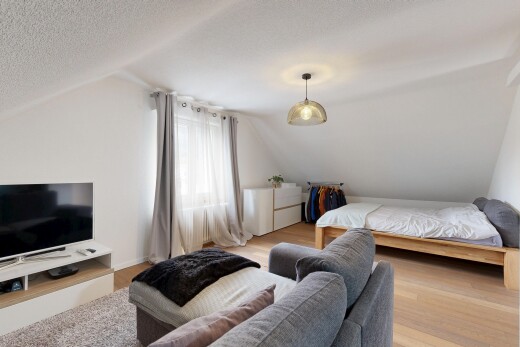 room with lofted ceiling, wood finished floors, and a textured ceiling