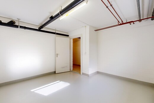 unfurnished room with finished concrete flooring and concrete block wall