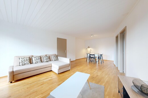 salon / salle à manger avec sol en finition bois, wood finish floor, cloison sèche, drywall, et inside property