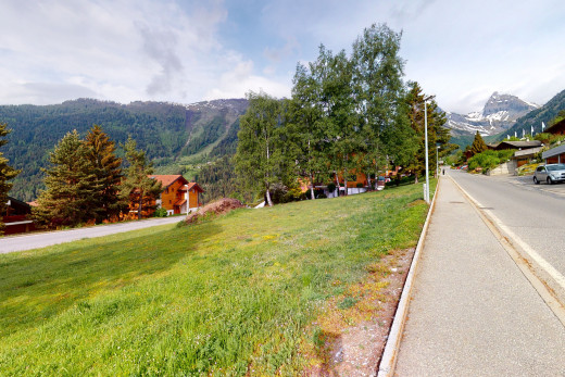 view of road with a yard and a mountain view