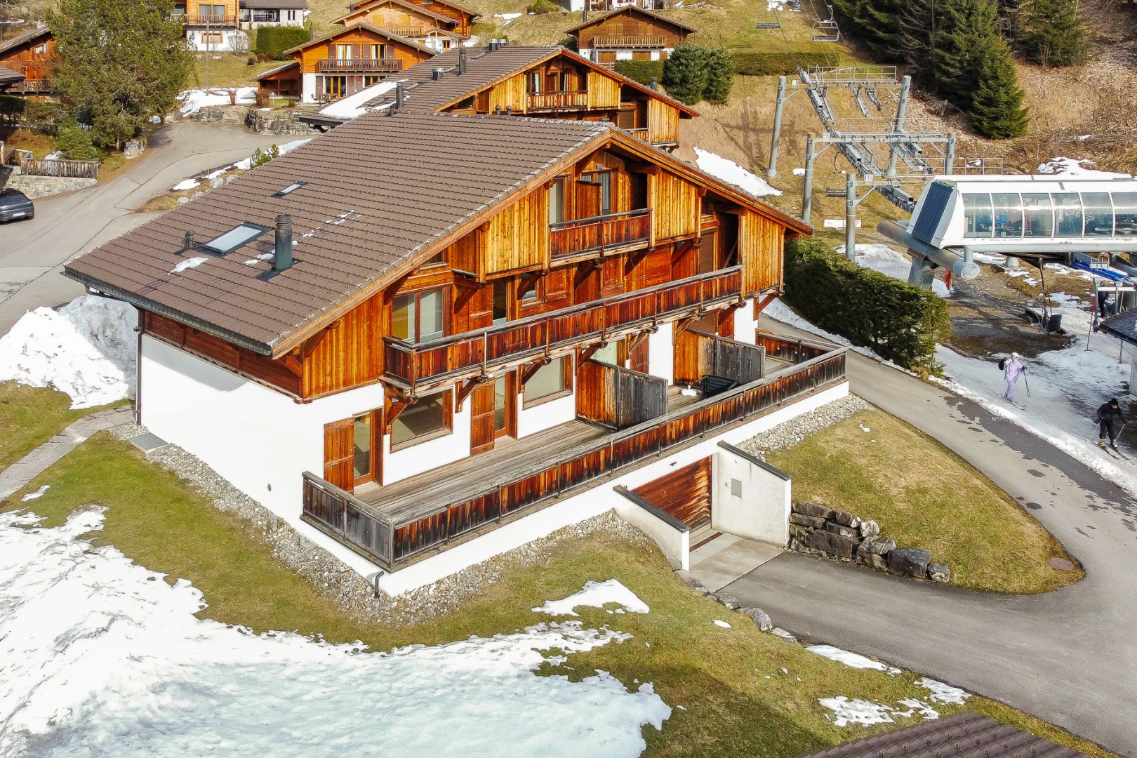 snow covered house featuring a balcony