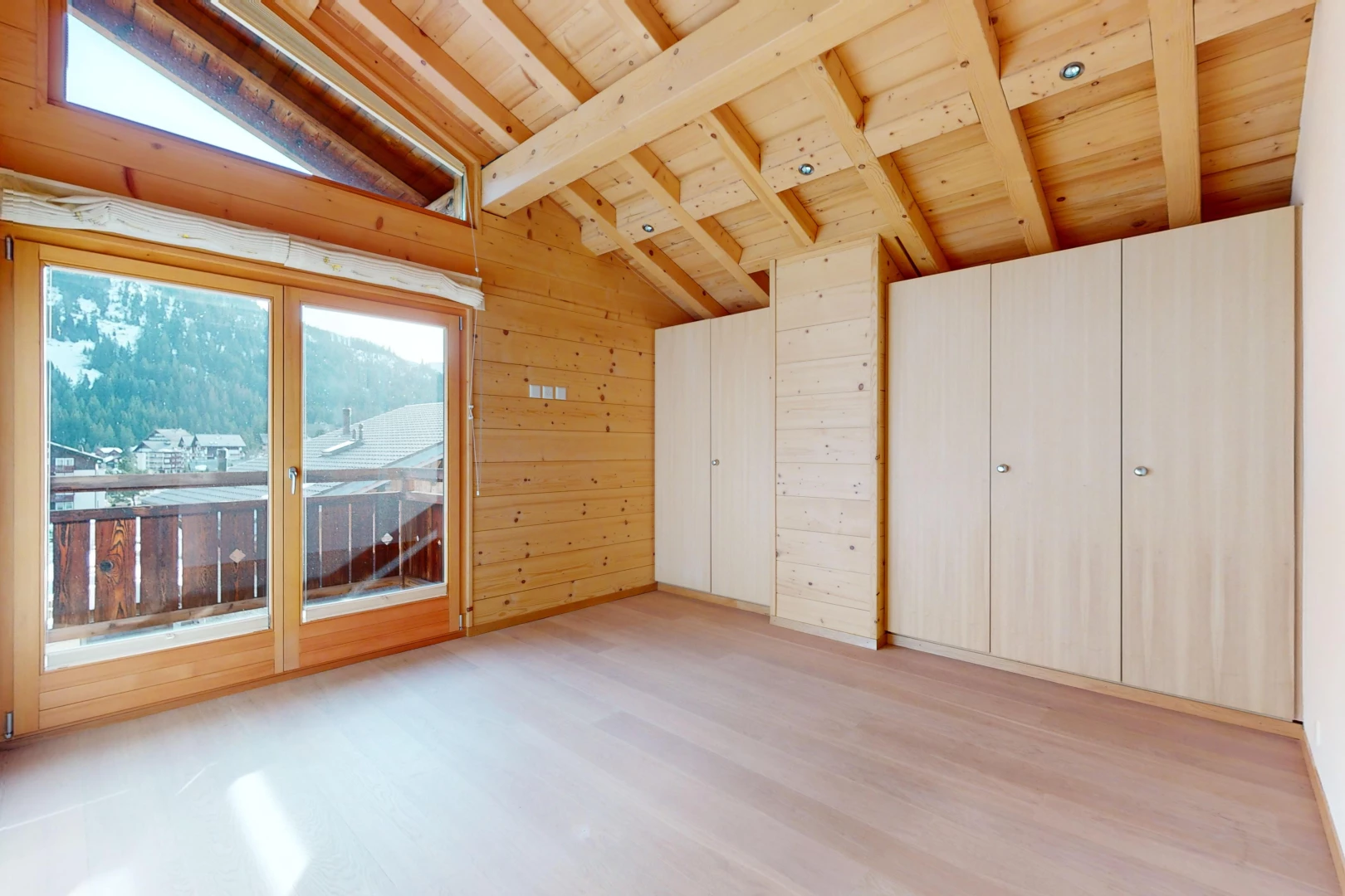 unfurnished room with lofted ceiling with beams, wood ceiling, wooden walls, and light wood-type flooring