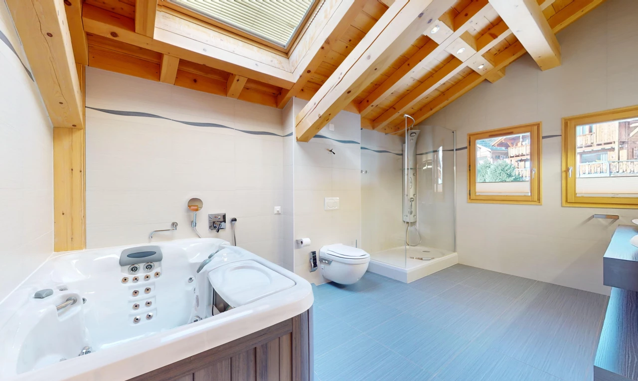 bathroom featuring plus walk in shower, vaulted ceiling with beams, tile flooring, and toilet