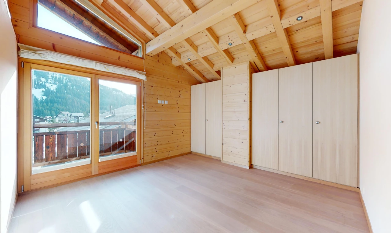 unfurnished room with lofted ceiling with beams, wood ceiling, wooden walls, and light wood-type flooring