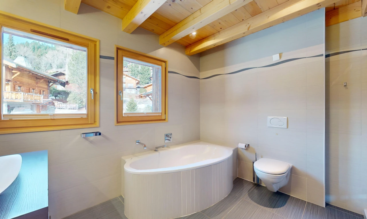 bathroom featuring toilet, tile floors, a bathing tub, beam ceiling, and wooden ceiling