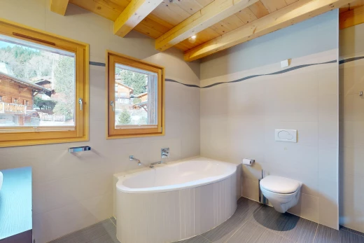 bathroom featuring toilet, tile floors, a bathing tub, beam ceiling, and wooden ceiling