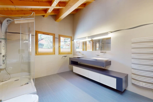 bathroom with toilet, a shower with door, large vanity, beam ceiling, and tile floors