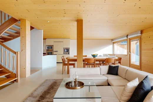 living / dining room with wood ceiling and concrete flooring