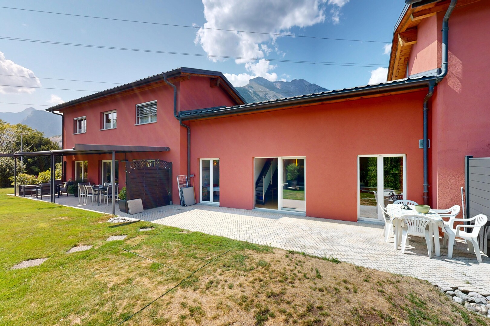 façade avec terrasse, bardage en stuc, pelouse, day time, et property visible