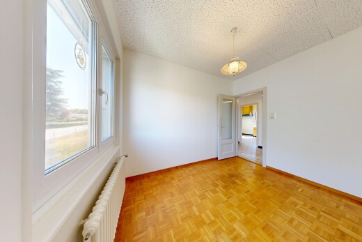 pièce vide avec radiateur, sol en finition bois, wood finish floor, plafond texturé, et textured ceiling