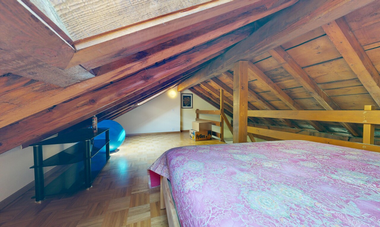 chambre avec vaulted ceiling, plafond voûté, wood finish floor, sol en finition bois, et low ceiling