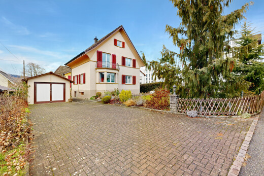 outdoor house featuring an outbuilding and stucco siding
