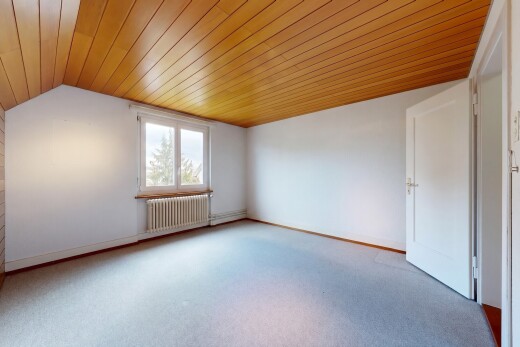 carpeted empty room featuring radiator and a vaulted wooden ceiling