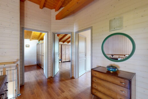 hallway with wood walls, a wooden ceiling with exposed beams, and wood-type flooring