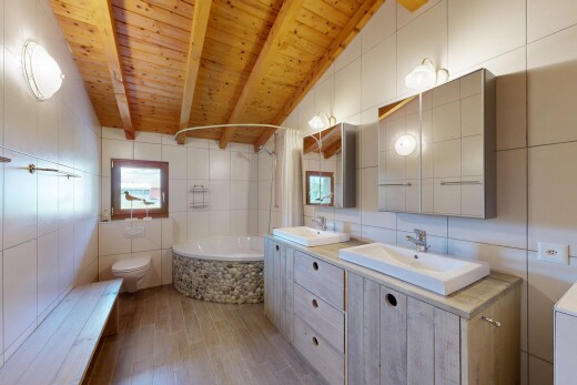 full bathroom with tile walls, wooden ceiling, double vanity, light wood-style floors, and lofted ceiling with beams