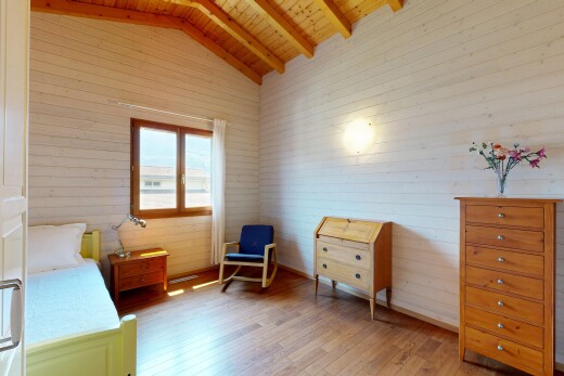 room featuring light wood-style flooring and a wood ceiling with exposed beams