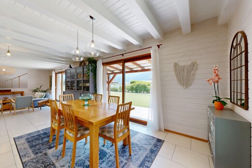 dining space featuring beamed ceiling and wooden walls