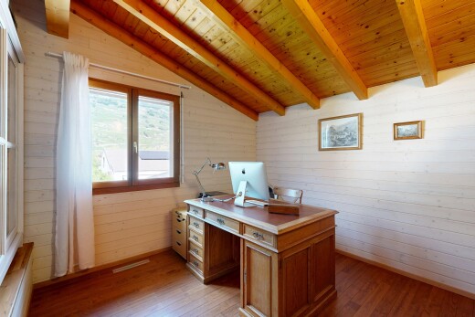 office space with wood walls, hardwood / wood-style flooring, and lofted ceiling with beams