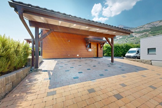 terrace featuring an attached carport and a mountain view